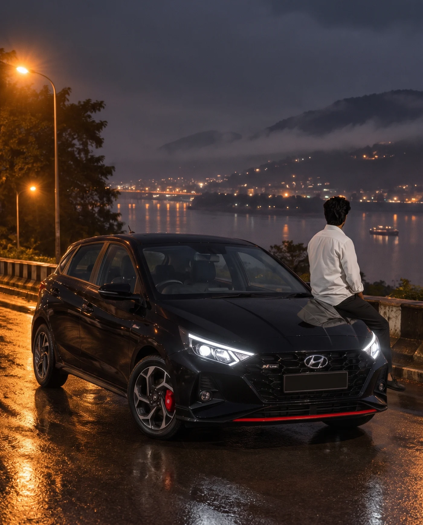 A black Hyundai i20 N Line parked by the Brahmaputra at night in Guwahati